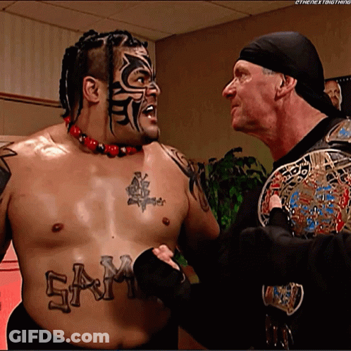 A Shirtless Wrestler With The Word Sam On His Chest GIF