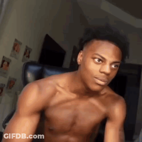 A Shirtless Young Man Is Sitting In A Chair In A Living Room . GIF