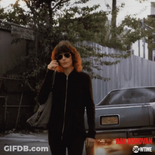 A Showtime Ad For Ray Donovan Features A Woman Talking On A Cell Phone GIF