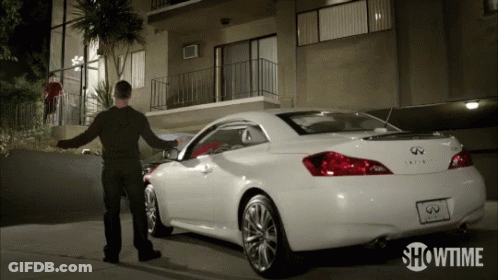 A Showtime Ad Shows A Man Standing Next To A White Infiniti GIF