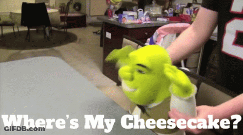 A Shrek Puppet Is Being Held By A Person With The Words Where 'S My Cheesecake GIF