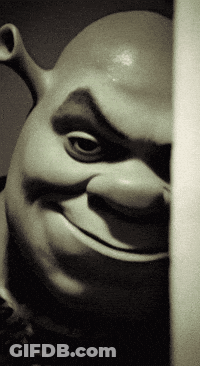A Shrek Statue Is Smiling And Looking At The Camera GIF
