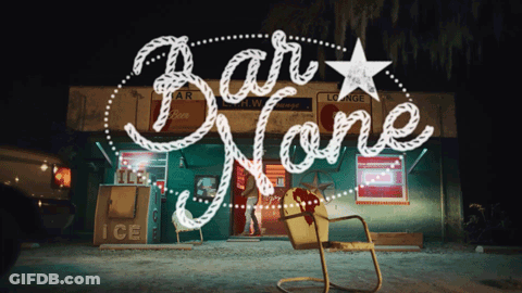 A Sign For Bar None With A Yellow Chair In Front Of It GIF