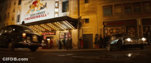 A Sign For Sean Connery Thunderball Hangs Above A Car GIF