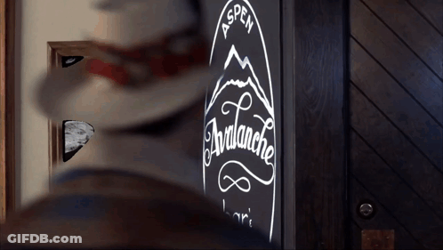 A Sign For The Aspen Avalanche Bar Is Lit Up In The Dark GIF