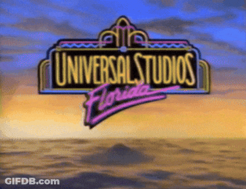 A Sign For Universal Studios Florida With A Sunset Background GIF