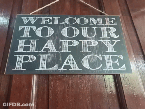 A Sign Hanging On A Wooden Wall Says Welcome To Our Happily Place GIF