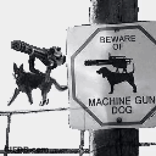 A Sign On A Pole That Says Beware Of Machine Gun Dogs GIF