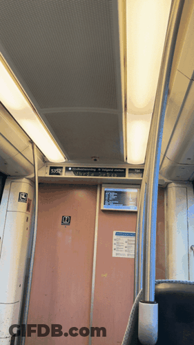 A Sign On The Ceiling Of A Train That Says ' Emergency Exit ' On It GIF