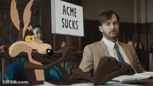 A Sign That Says Acme Sucks Next To A Man In A Suit GIF