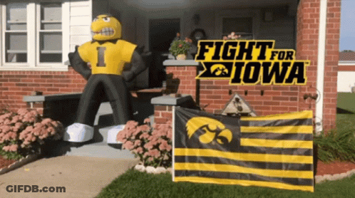 A Sign That Says Fight For Iowa Is On A Brick House GIF