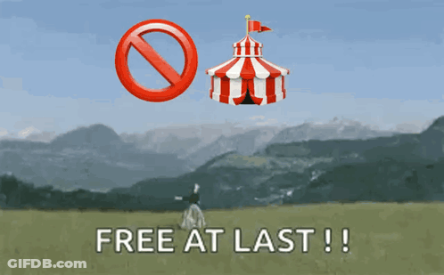 A Sign That Says Free At Last With A Red And White Tent In The Background GIF