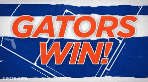 A Sign That Says Gators Win On A Blue And White Striped Background GIF