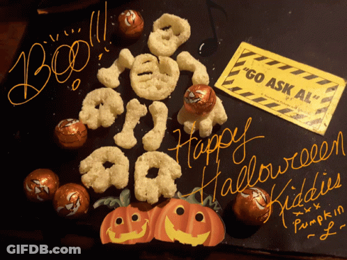 A Sign That Says " Go Ask Al " Sits Next To A Display Of Halloween Treats GIF