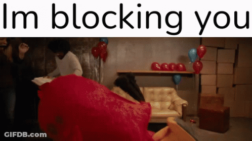 A Sign That Says I 'M Blocking You In Front Of A Couch GIF