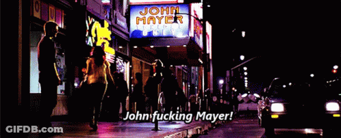 A Sign That Says John Mayer On It Is Lit Up At Night GIF
