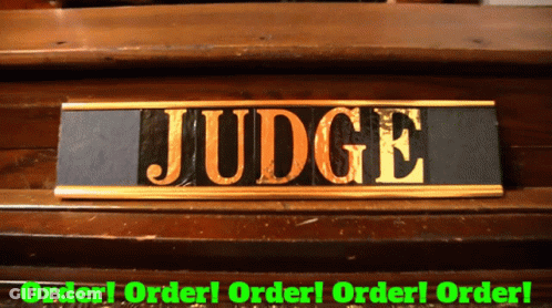 A Sign That Says Judge On It In Gold GIF