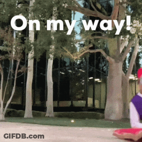 A Sign That Says On My Way In Front Of A Building GIF