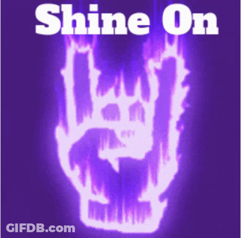 A Sign That Says Shine On With A Skull In Flames GIF