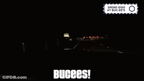 A Sign That Says Spend $ 100 At Buc-Ee 'S Is Above A Dark Highway GIF