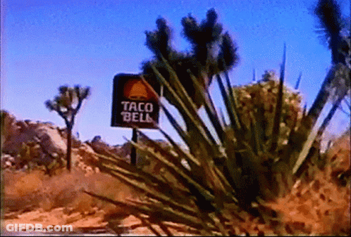 A Sign That Says Taco Bell Is In The Desert GIF