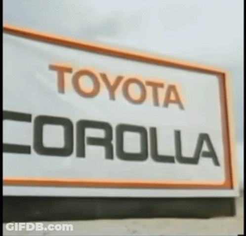 A Sign That Says Toyota Corolla In Black And Orange GIF