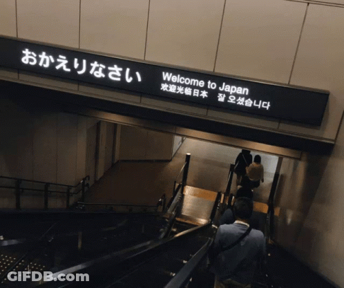 A Sign That Says Welcome To Japan Is Above A Set Of Stairs GIF