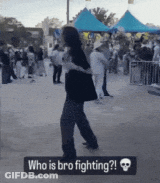 A Sign That Says Who Is Bro Fighting In Front Of A Crowd GIF