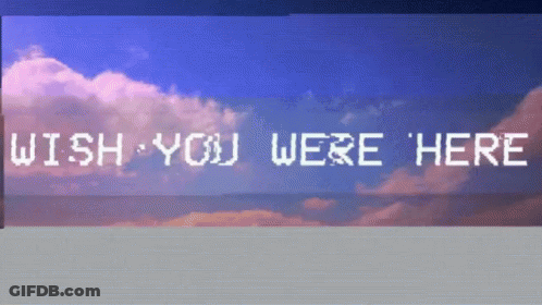 A Sign That Says Wish You Were Here In Front Of A Cloudy Sky GIF
