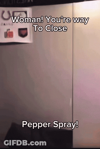 A Sign That Says Woman You 'Re Way To Close Pepper Spray On It GIF