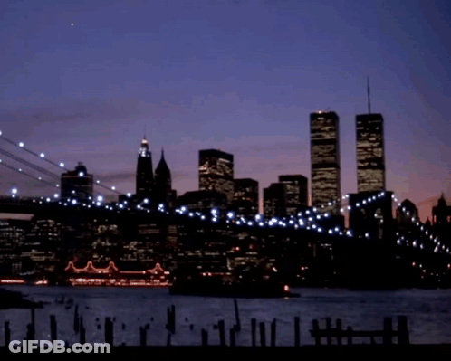 A Silhouette Of A City Skyline With The Twin Towers In The Background GIF