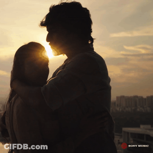 A Silhouette Of A Man And A Woman Hugging With The Words Sony Music On The Bottom GIF