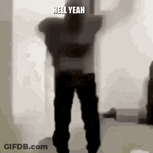 A Silhouette Of A Man Dancing In A Room With The Words `` Hell Yeah '' Written On The Bottom Of The Image . GIF