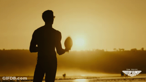 A Silhouette Of A Man Holding A Football In Front Of The Sun With The Words Tom Cruise Top Gun Marina On The Bottom Righ GIF