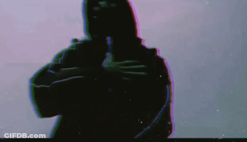 A Silhouette Of A Man In A Hooded Jacket Is Holding A Gun In His Hand . GIF