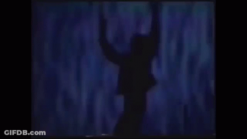 A Silhouette Of A Man In A Suit With His Arms Outstretched . GIF