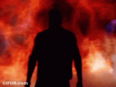 A Silhouette Of A Man Is Standing In Front Of A Red Background GIF