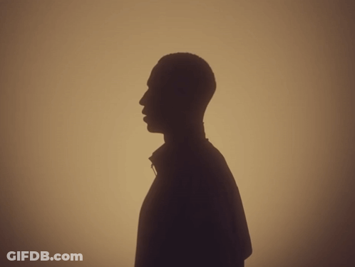 A Silhouette Of A Man 'S Head Is Against A Tan Background GIF