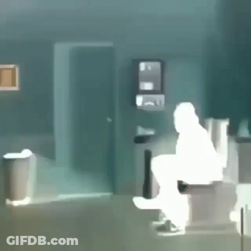 A Silhouette Of A Man Sitting On A Toilet In A Bathroom GIF