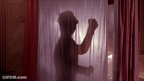 A Silhouette Of A Man Standing Behind A Pink Curtain GIF