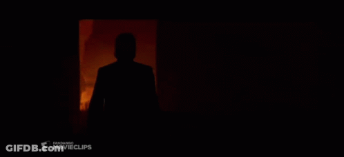 A Silhouette Of A Man Standing In A Dark Room With A Movie Clips Logo In The Corner GIF