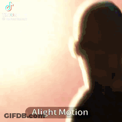 A Silhouette Of A Man Standing In Front Of A Pink Background With The Words Alight Motion On The Bottom . GIF
