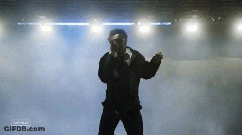 A Silhouette Of A Man Standing In Front Of A Stage With The Word Cancella On The Bottom Right GIF