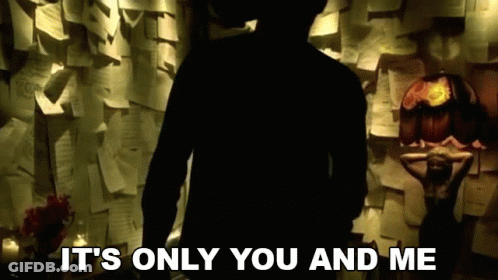A Silhouette Of A Man Standing In Front Of A Wall Of Papers With The Words It 'S Only You And Me GIF
