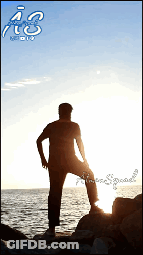 A Silhouette Of A Man Standing On A Rock Overlooking A Body Of Water With The Letters A & S Above Him GIF