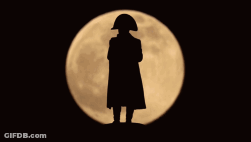 A Silhouette Of A Man With A Napoleon Hat Standing In Front Of A Full Moon GIF