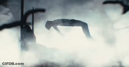 A Silhouette Of A Person Doing A Handstand In The Fog . GIF