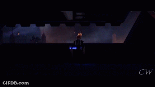 A Silhouette Of A Person Holding A Lightsaber In Front Of A Burning Building GIF