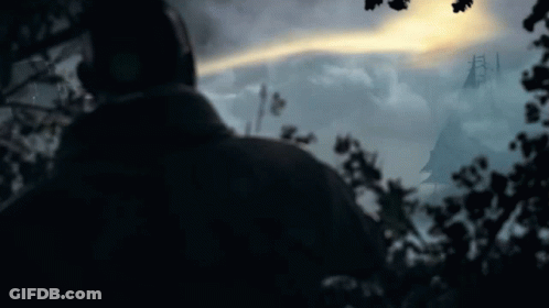 A Silhouette Of A Person In A Dark Forest With Trees In The Foreground GIF