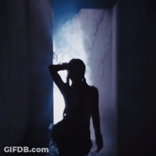 A Silhouette Of A Person In A Dark Room With Smoke Coming Out Of The Doorway GIF